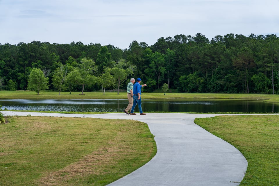 commercial maintenance account manager and customer inspecting lawn 3-1