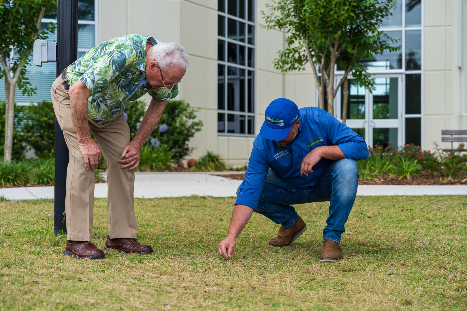 commercial maintenance account manager and customer inspecting lawn-1