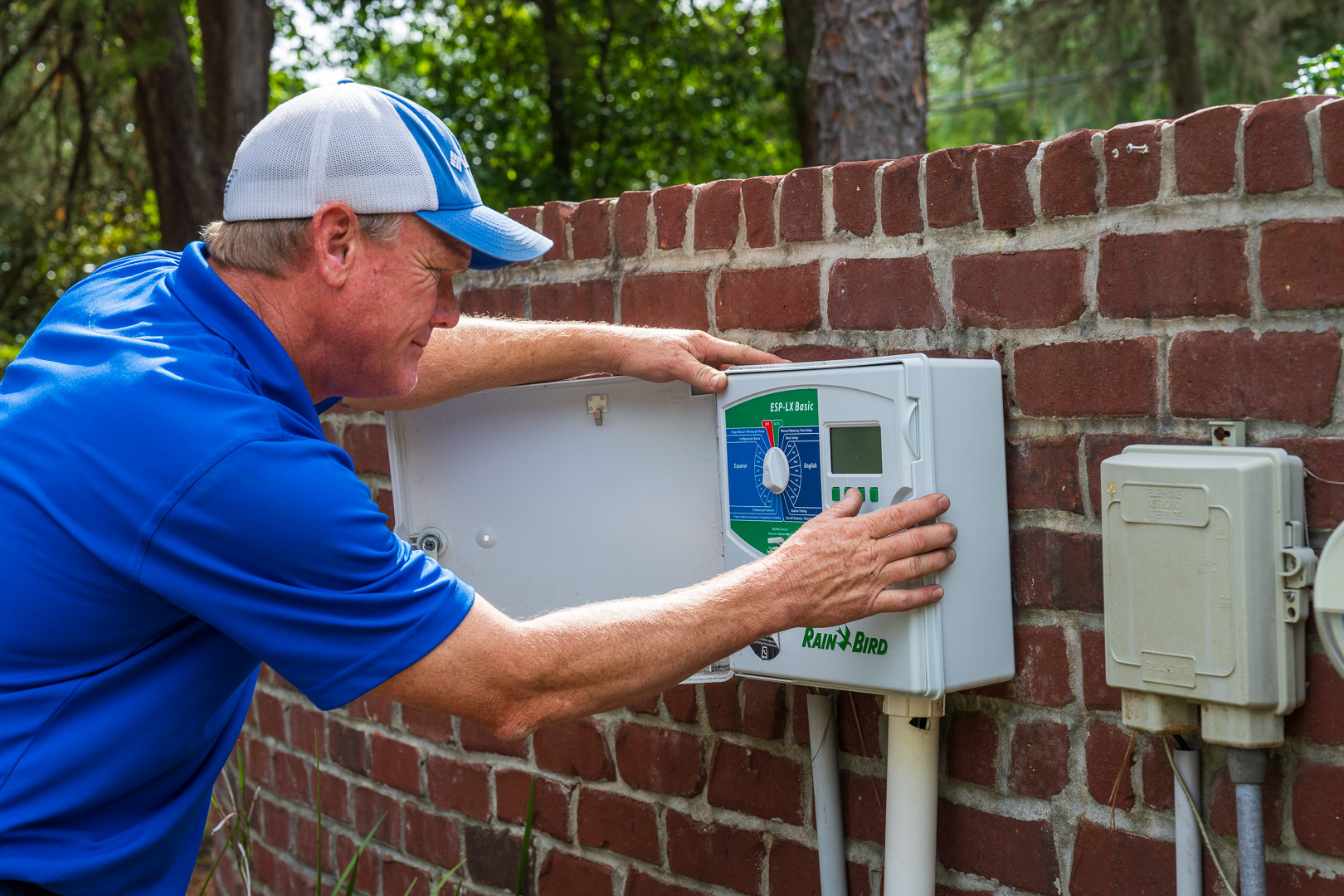 irrigation techician calibrating a lawn sprinkler controller 2