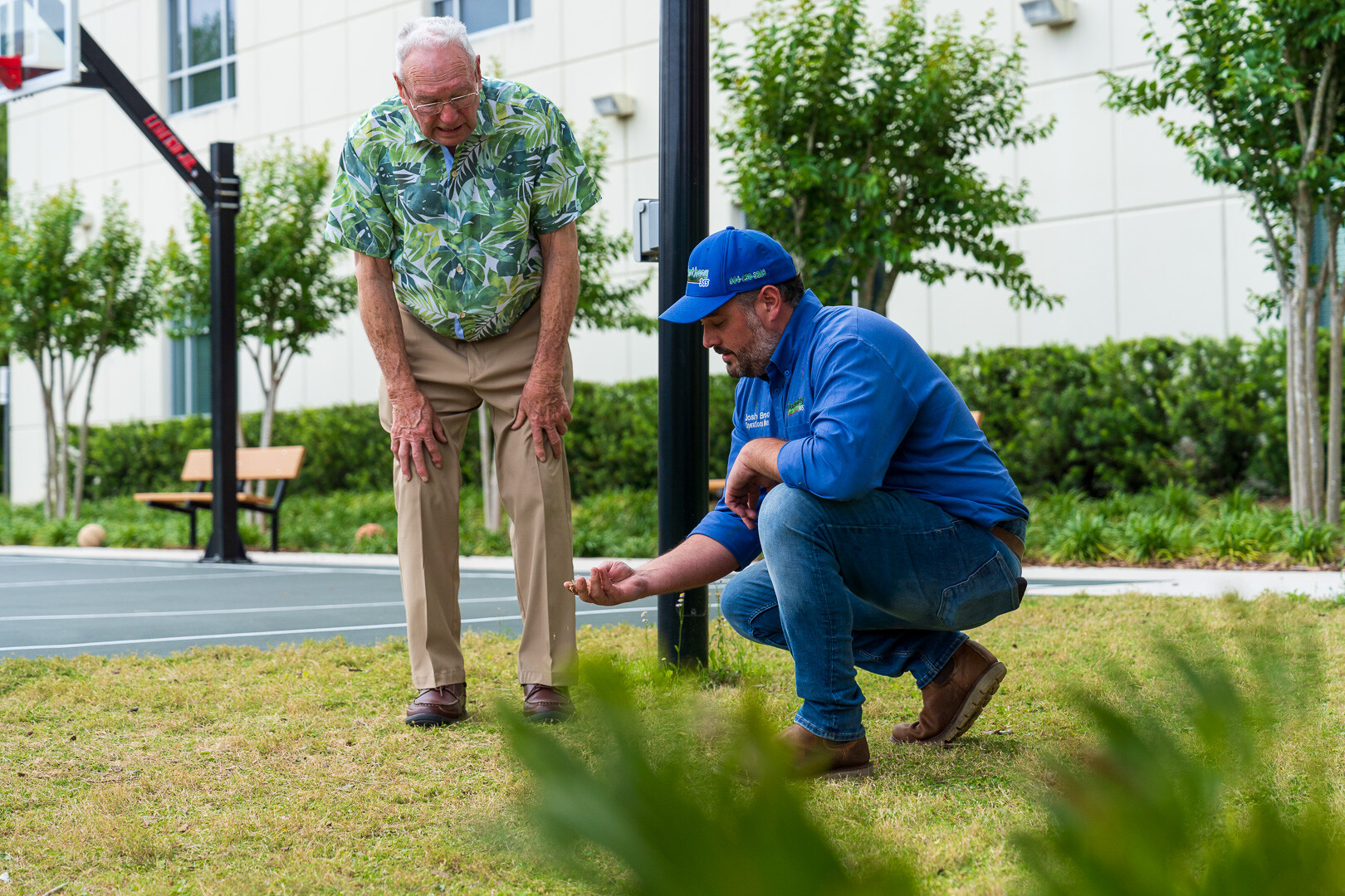 commercial maintenance account manager and customer inspecting lawn 2