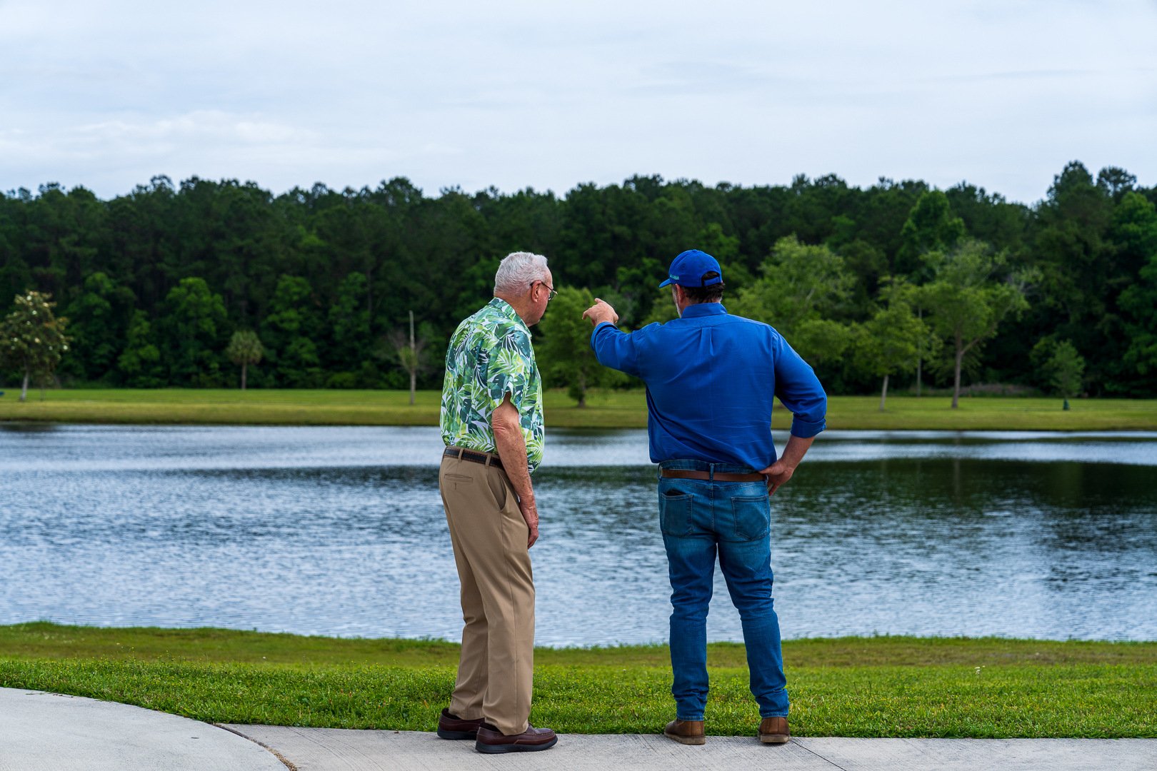 commercial maintenance account manager and customer inspecting lawn 4