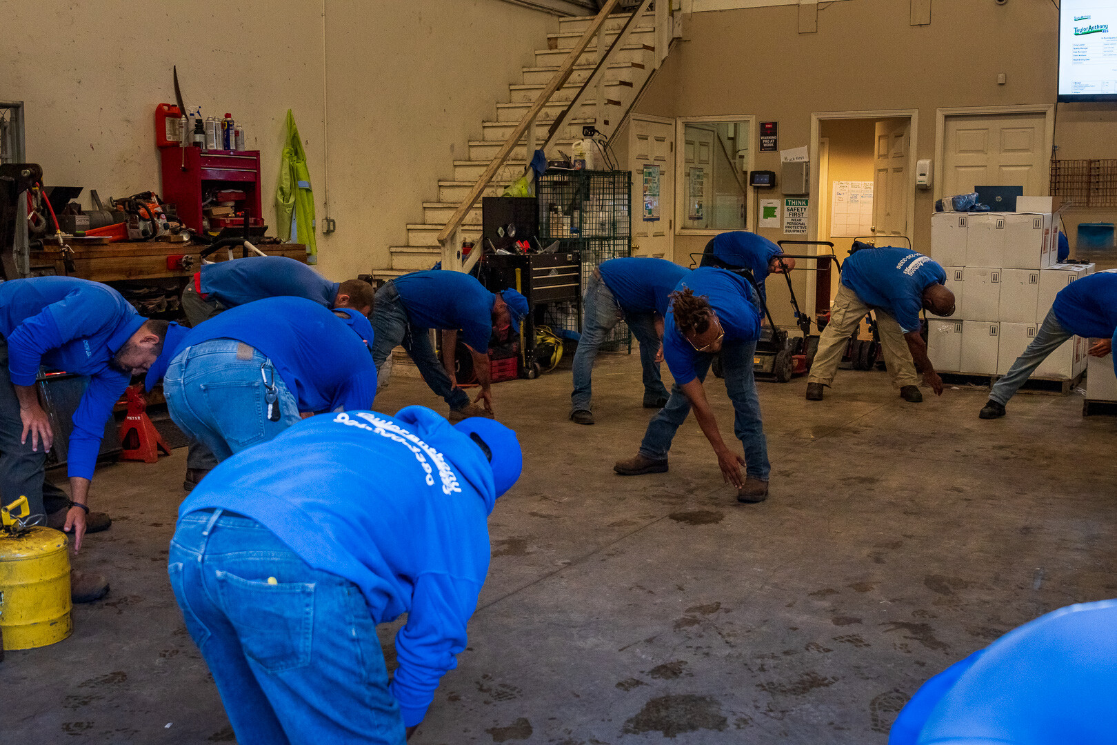 team members stretching in morning meeting at garage 2