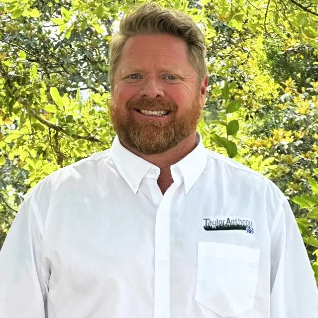 Professional headshot of David Clifton, Commercial Development Manager, wearing a white button-down shirt.